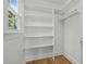 Bright walk-in closet features custom shelving and a storage rod at 105 Toynbee Pl, Chapel Hill, NC 27514