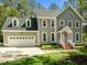 Charming two-story home with a two-car garage, manicured lawn and mature trees offering great curb appeal at 105 Toynbee Pl, Chapel Hill, NC 27514