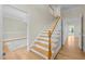 Light-filled foyer with wood floors and staircase leading to the second level at 105 Toynbee Pl, Chapel Hill, NC 27514