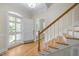 Foyer featuring hardwood floors, staircase, and a view of the front door, creating a welcoming entrance at 105 Toynbee Pl, Chapel Hill, NC 27514