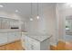 Kitchen with an island, granite countertops, stainless appliances and hardwood floors at 105 Toynbee Pl, Chapel Hill, NC 27514