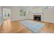 Light filled living room with fireplace and beautiful hardwood flooring at 105 Toynbee Pl, Chapel Hill, NC 27514