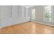 Office with built-in bookcases, cabinets, hardwood floors, and natural light creating a functional workspace at 105 Toynbee Pl, Chapel Hill, NC 27514