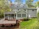 Expansive backyard of a two-story home with patio, screened porch, and well-manicured lawn at 105 Toynbee Pl, Chapel Hill, NC 27514