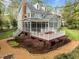 A backyard with a deck, patio, walkway and landscaped garden of an elegant two-story home at 105 Toynbee Pl, Chapel Hill, NC 27514