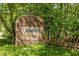 The Chandler's Green neighborhood sign is surrounded by greenery at 105 Toynbee Pl, Chapel Hill, NC 27514