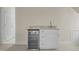 This carpeted bonus room features a modern wet bar with a granite countertop and mini fridge at 105 Toynbee Pl, Chapel Hill, NC 27514