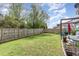 Green backyard with wood fence, patio furniture, and vibrant landscaping at 1109 Forest Willow Ln, Morrisville, NC 27560
