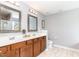 Well-lit bathroom featuring double sinks, granite countertops, and modern fixtures for convenience at 1109 Forest Willow Ln, Morrisville, NC 27560