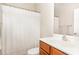 Clean bathroom with ample lighting, a wooden vanity, and a shower curtain at 1109 Forest Willow Ln, Morrisville, NC 27560