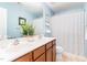 Bright bathroom featuring double sinks, wood cabinets, and a shower with a curtain at 1109 Forest Willow Ln, Morrisville, NC 27560