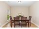 Bright dining room with wood flooring, natural light from the large window, and seating for six at 1109 Forest Willow Ln, Morrisville, NC 27560