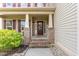 Inviting front porch with brick stairs and columns, paneled front door, and 'Hey Friends' sign at 1109 Forest Willow Ln, Morrisville, NC 27560