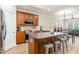 Eat-in kitchen with hardwood floors, stainless steel appliances, and large center island with barstool seating at 1109 Forest Willow Ln, Morrisville, NC 27560