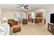 Open concept living room with wood flooring, fireplace, and archway views of the kitchen and staircase at 1109 Forest Willow Ln, Morrisville, NC 27560