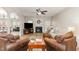 Spacious living room featuring a fireplace, ceiling fan, hardwood floors, and lots of natural light at 1109 Forest Willow Ln, Morrisville, NC 27560