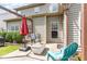 Inviting patio with seating area, shade umbrella, and outdoor lights at 1109 Forest Willow Ln, Morrisville, NC 27560