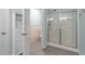 This bathroom features a large walk-in shower, white cabinet, and wainscotting at 1126 Russet Ln, Apex, NC 27523