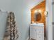 Bathroom featuring wood accent wall, vanity with storage, and modern lighting at 1126 Russet Ln, Apex, NC 27523