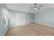 Bright bedroom featuring a modern ceiling fan and neutral carpeting at 1126 Russet Ln, Apex, NC 27523