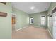 A versatile bonus room with a door leading to the exterior and wood accent wall visible through a doorway at 1126 Russet Ln, Apex, NC 27523