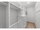 Walk-in closet with white built-in shelves and drawers for organized storage at 1126 Russet Ln, Apex, NC 27523