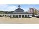Elegant clubhouse with a striking tower, framed by manicured hedges and a paved area at 1126 Russet Ln, Apex, NC 27523