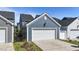 A detached garage with a white door, matching trim, and blue siding at 1126 Russet Ln, Apex, NC 27523