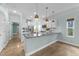 Open-concept kitchen with stainless steel appliances, a breakfast bar, and plenty of natural light at 1126 Russet Ln, Apex, NC 27523