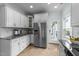 Kitchen featuring stainless steel appliances, white cabinetry, and granite countertops at 1126 Russet Ln, Apex, NC 27523