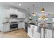 Bright, modern kitchen featuring stainless steel appliances and a stylish island with granite countertops at 1126 Russet Ln, Apex, NC 27523