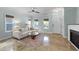 Bright living room featuring modern decor, a ceiling fan, and a decorative fireplace at 1126 Russet Ln, Apex, NC 27523