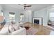 Modern living room with neutral tones, a stylish fireplace, and plenty of natural light at 1126 Russet Ln, Apex, NC 27523