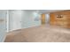 Spacious living room with unique wooden accent wall, neutral carpet, and plenty of natural light at 1126 Russet Ln, Apex, NC 27523