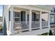 Charming porch with white columns, a white railing, and comfortable outdoor seating at 1126 Russet Ln, Apex, NC 27523