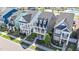 An aerial view of tree lined street showing sidewalk, and colorful homes at 1126 Russet Ln, Apex, NC 27523