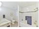 Bright bathroom featuring a tiled shower/tub, white vanity, and neutral décor at 116 Crawford Rd, Hillsborough, NC 27278