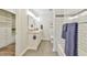 Bathroom with a dual sink vanity, tiled shower/tub, and walk-in closet at 116 Crawford Rd, Hillsborough, NC 27278