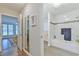 Hallway view leads to bath with white tile, tub, and shower; bedroom visible in opposite doorway at 116 Crawford Rd, Hillsborough, NC 27278