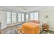 Bright bedroom with a ceiling fan, hardwood floors, and natural light from the windows at 116 Crawford Rd, Hillsborough, NC 27278