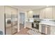 A bright kitchen with stainless steel appliances, white cabinets, and modern countertops at 116 Crawford Rd, Hillsborough, NC 27278