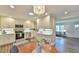 Eat-in kitchen with updated appliances, white cabinetry, subway tile backsplash, and decorative lighting at 116 Crawford Rd, Hillsborough, NC 27278