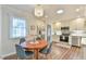 Charming eat-in kitchen featuring updated appliances, and a view to the backyard through a large window at 116 Crawford Rd, Hillsborough, NC 27278