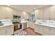 Well-lit kitchen features stainless steel appliances, white cabinetry, and stylish backsplash and countertops at 116 Crawford Rd, Hillsborough, NC 27278