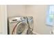 The well-lit laundry area is equipped with modern, matching front-loading machines at 116 Crawford Rd, Hillsborough, NC 27278