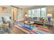 Bright living room with a large window, colorful rug, modern furniture and a sliding barn door at 116 Crawford Rd, Hillsborough, NC 27278