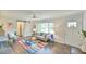 Cozy living room with a large window, modern gray sofa, colorful rug, and a sliding barn door at 116 Crawford Rd, Hillsborough, NC 27278