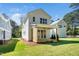 Lush green backyard with covered patio, sliding doors, and manicured landscaping at 1207 Chaney Rd, Raleigh, NC 27606