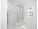 Bright bathroom featuring glass shower door, rain shower and built-in bench at 1207 Chaney Rd, Raleigh, NC 27606