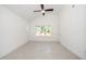 Bright bedroom with vaulted ceiling featuring a large window and fan at 1207 Chaney Rd, Raleigh, NC 27606